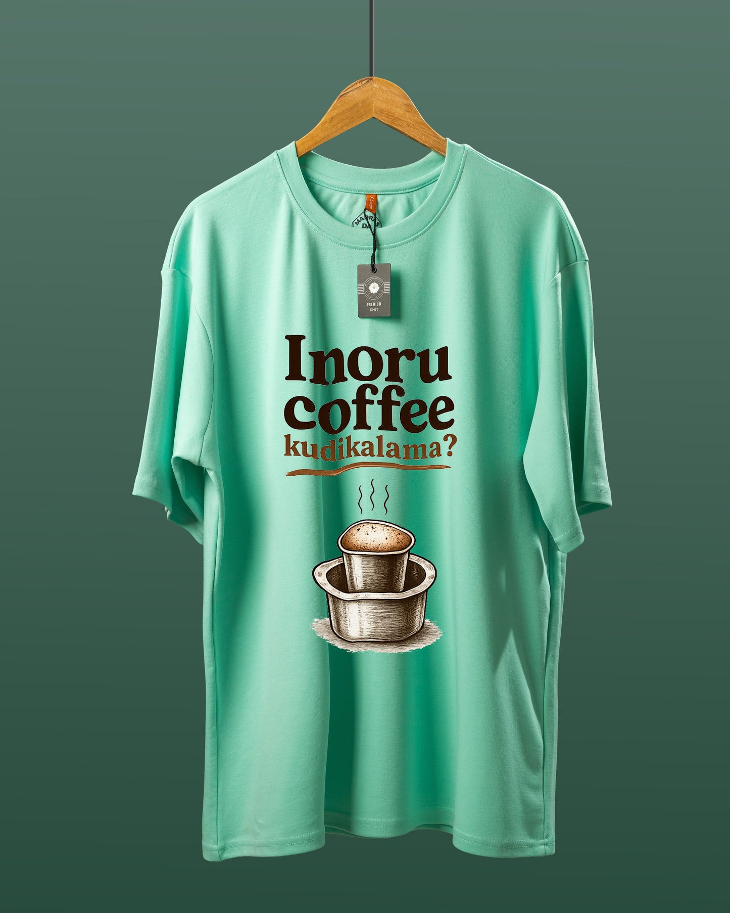 DUMM Inoru Coffee Kudikalama oversized t-shirt in mint green on wooden hanger