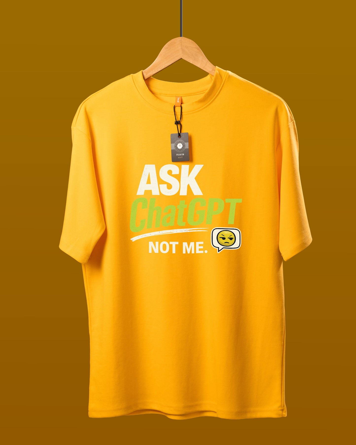 DUMM Ask ChatGPT Not Me oversized t-shirt in mustard yellow on wooden hanger
