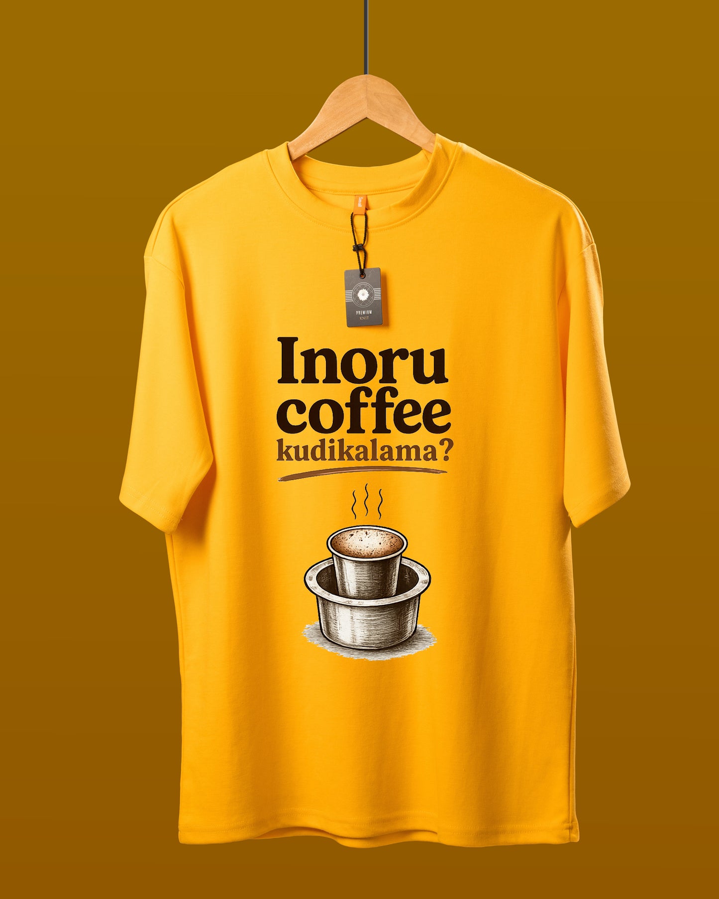 DUMM Inoru Coffee Kudikalama oversized t-shirt in mustard yellow on wooden hanger