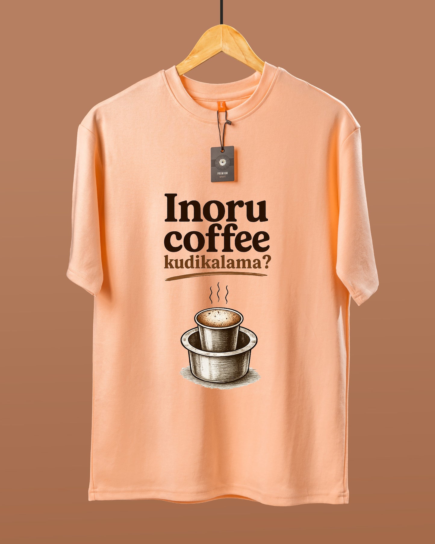 DUMM Inoru Coffee Kudikalama oversized t-shirt in peach on wooden hanger